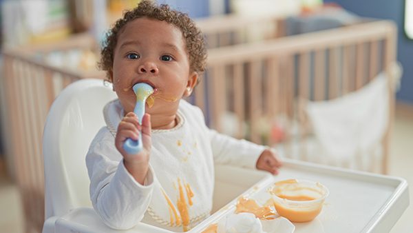 Girl eating puree infant